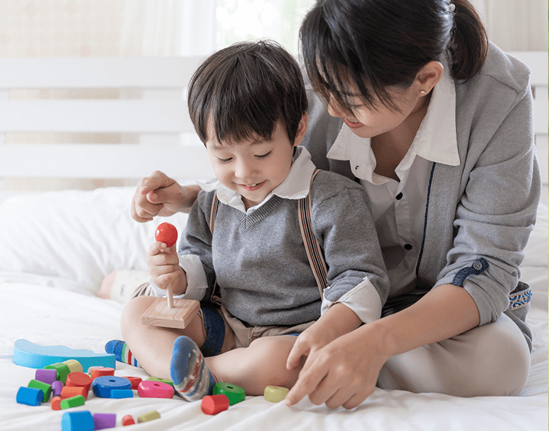 Caregiver Engaged in Educational Playtime Activities with Child